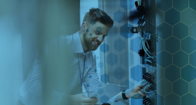 Man connecting cables in a datacentre