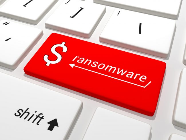Partial image of a keyboard with the Enter key highlighted in red and labeled 'ransomware' and a dollar sign. 