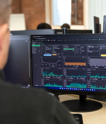 Professional monitoring system performance on dual screens in an office setting