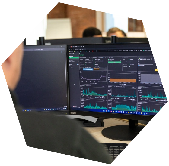 Close-up of computer monitors displaying real-time data and analytics dashboard