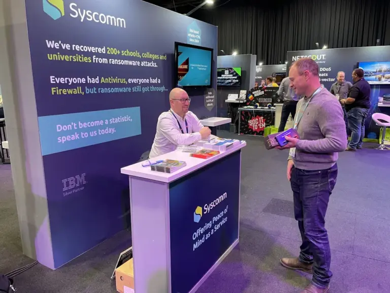 Syscomm team talking with visitors on the stand at last year's Jisc Security Conference