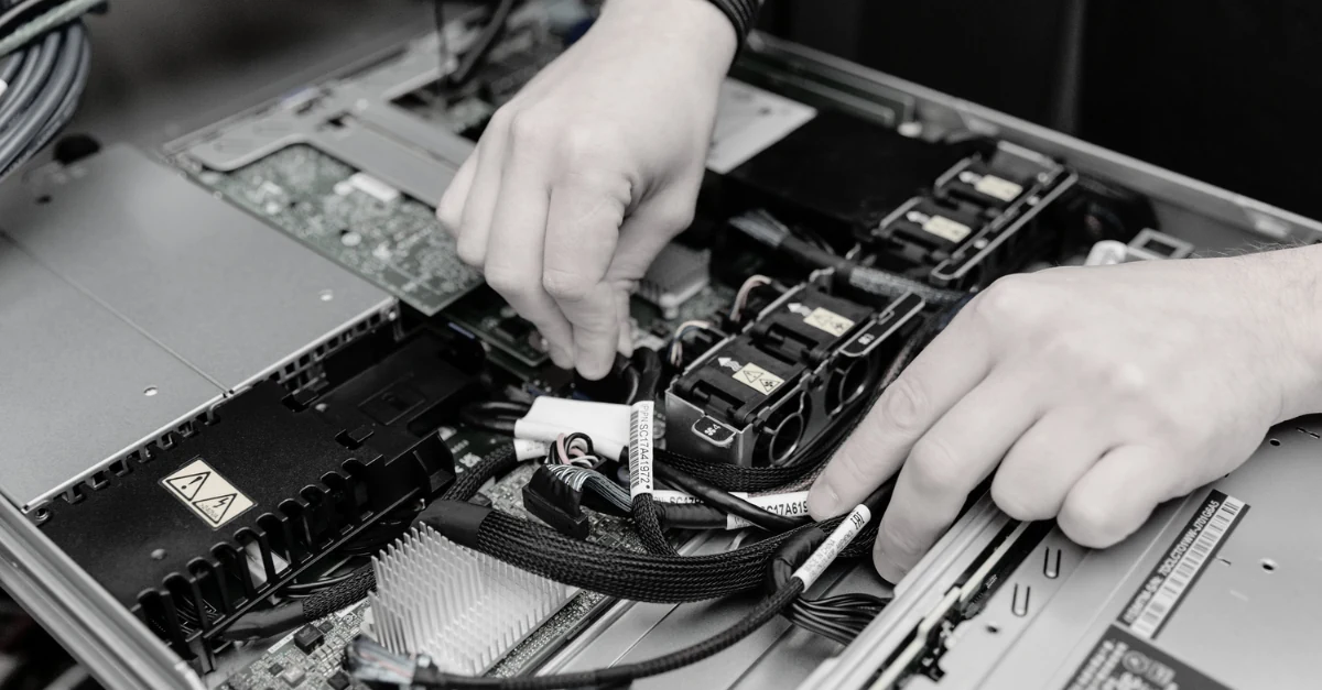 Engineer installing network switch hardware in a server rack