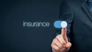 Hand switching on a toggle next to the word insurance, representing cyber insurance cover