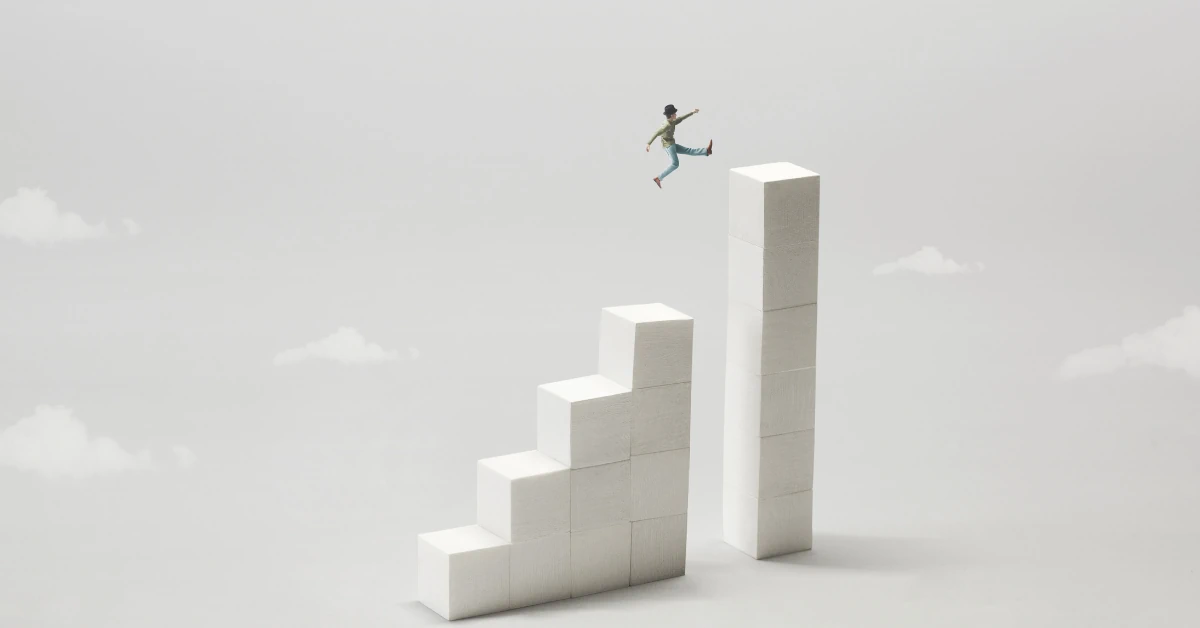 Small figure leaping across a gap from a staircase of white blocks to a taller column, representing ransomware recovery