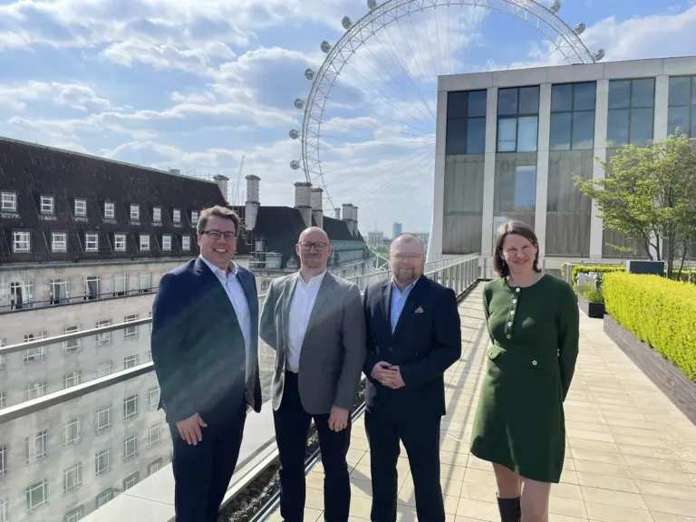 Syscomm team on the IBM South Bank roof terrace with the London Eye behind them