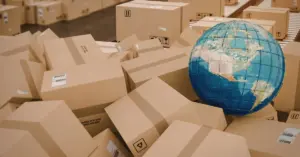 Globe resting among scattered cardboard parcels, representing global transport and logistics