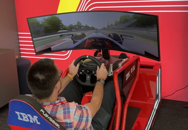 Guest using the IBM and Ferrari driving simulator at the IBM Innovation Studio, London