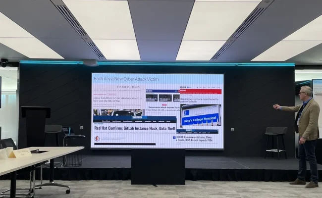Neil McGovern of IBM presenting recent cyber attack headlines at Defending Your Data, IBM London